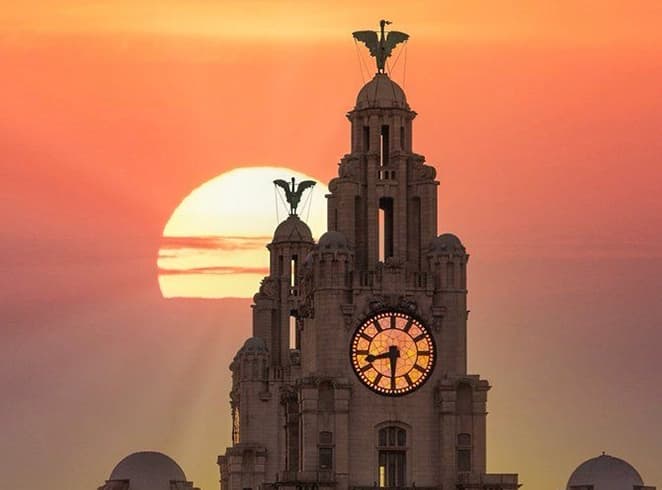 Liverpool Skyline and Royal Liver Building liverpool royal liver building at sunset near a church in Liverpool landmark view